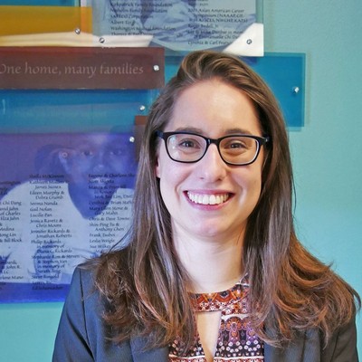 Student Smiling in Front of Presentation