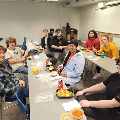 Students have dinner during debate practice