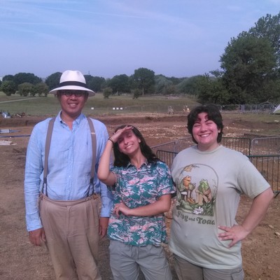 three people in a field doing archeology