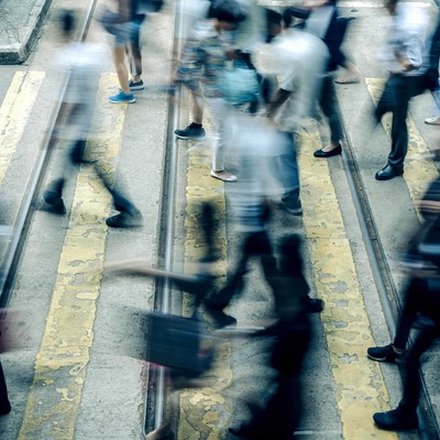 A blur of people at a pedestrian crossing