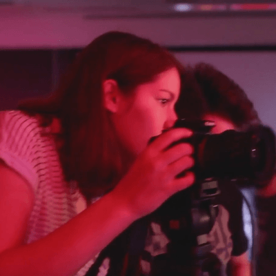 Two Students Look Through a Camera