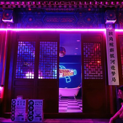 Photo looking into building with neon in China