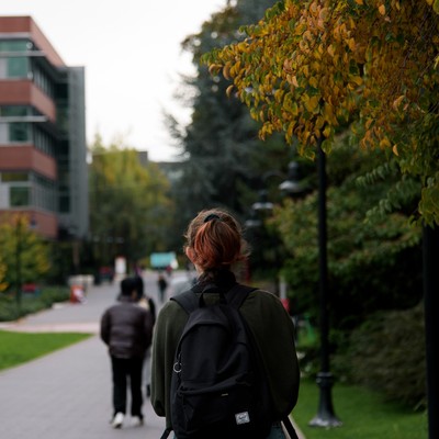 Back view of students walking to class in the fall