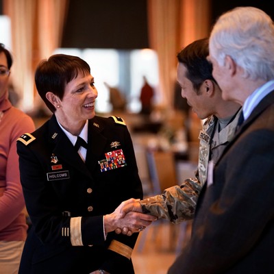 Image of Barbara Holcomb shaking hands with event attendees