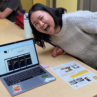 Student with computer excited about project