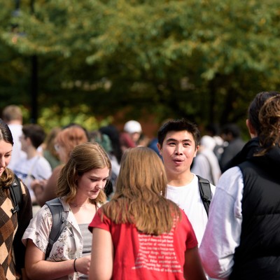 A group of people standing outside.