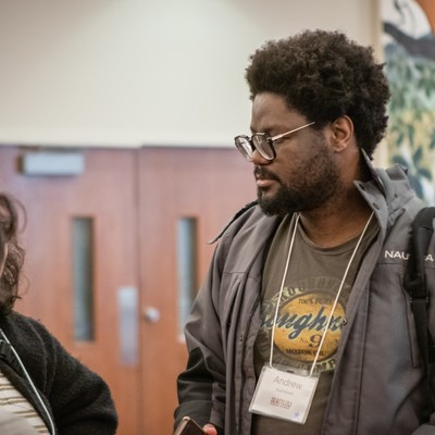 A graduate student wearing a nametag at an event on campus