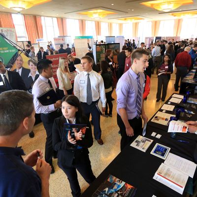 Attendees interacting at a busy career fair event.