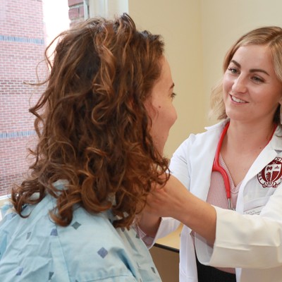 A female doctor examining a patient's neck.
