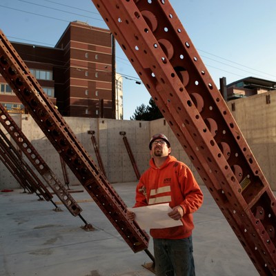 A man standing in front of a construction site.
