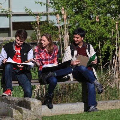 A group of people sitting on a bench.