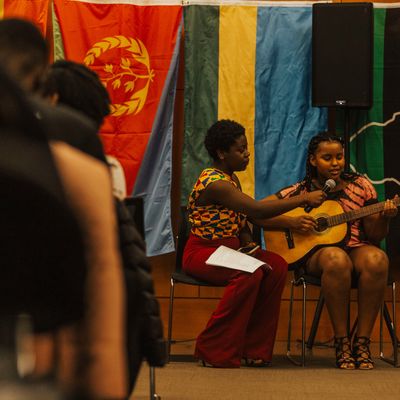 Students sing and play guitar at event