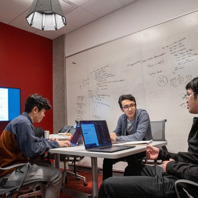 A group of people sitting around a table in a conference room.