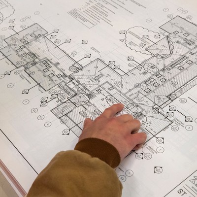 A man looking at blueprints.