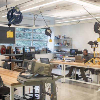 A view of a lab with people working at desks.