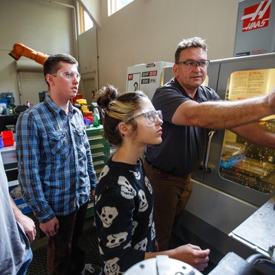 A group of people looking at a machine.