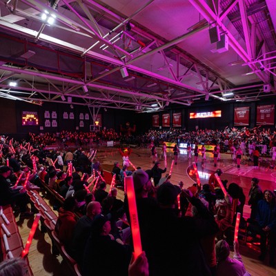 crowd cheering and waving light sticks at the Redhawk Center