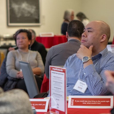 A man sitting at a table with a laptop.