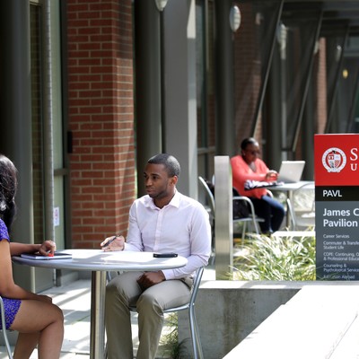 A man and woman sitting at a table.