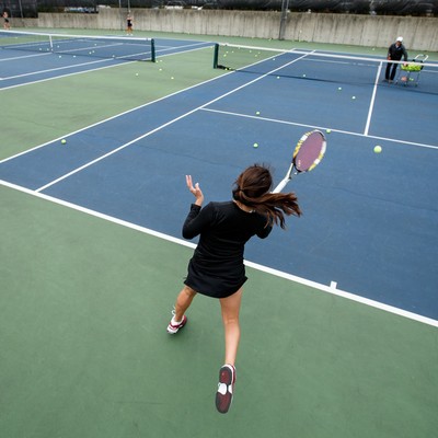 A woman playing tennis on a tennis court.