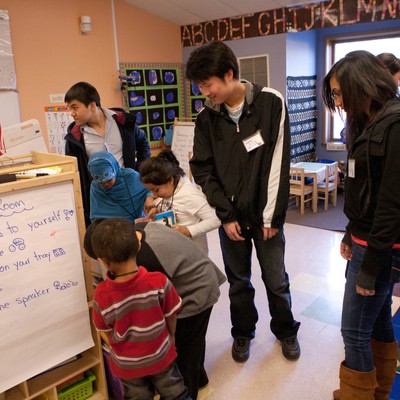 A group of people standing in a classroom.