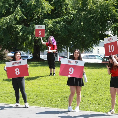 A group of women holding signs.