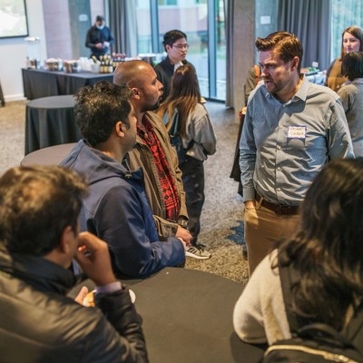 Students talking together at a welcome event for the Master's in Business Analytics program