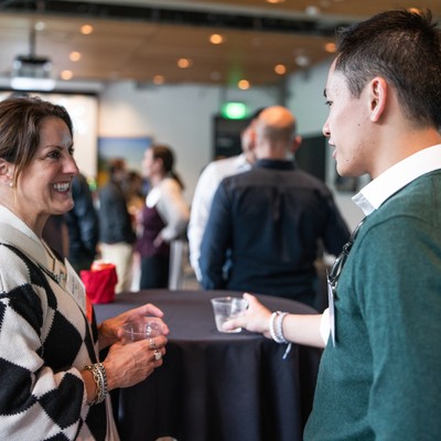 Two alumni talking at a meetup