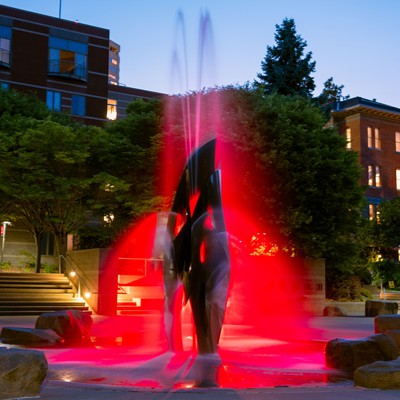 Fountain in the Quad lit up red