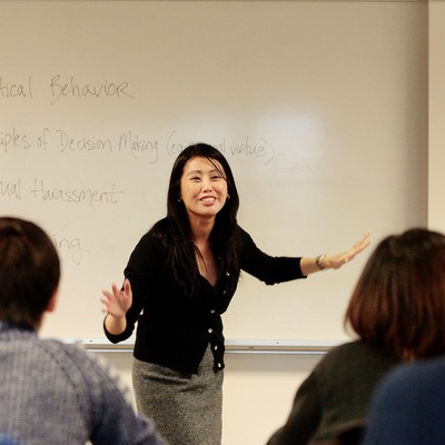 A teacher in front of a whiteboard in class