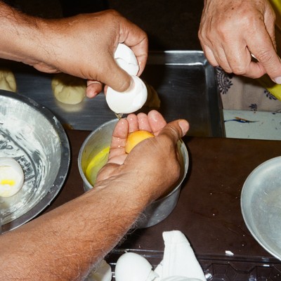 a close up of hands making an egg dish