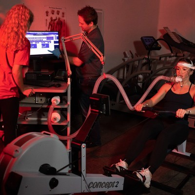 Student and instructor looking at results during rowing test