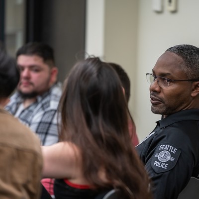Photo of students and police officer in discussions
