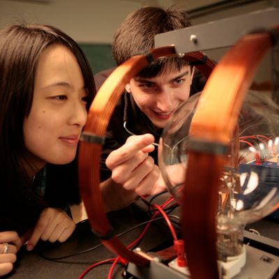 Students working on a plasma tube