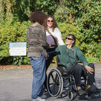Family weekend on campus. A person on wheelchair talking with other parents