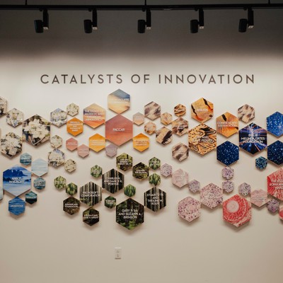 colorful octagonal plaques with donor names on white wall