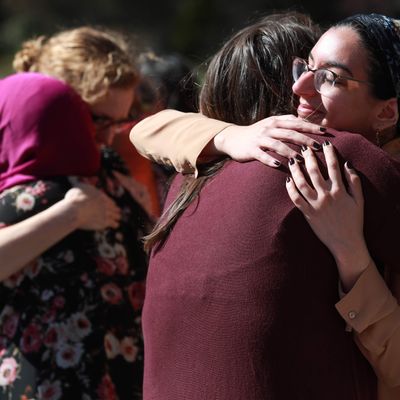 Two pairs pf women hugging each other