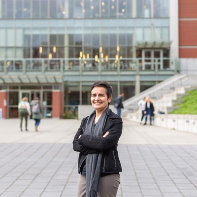 A woman standing in front of a library