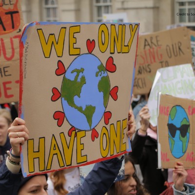 Photo of poster at climate march with drawing of Earth text we only have one