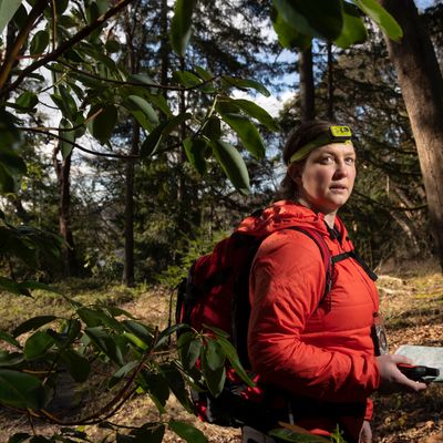 a woman in a forest looking at the camera