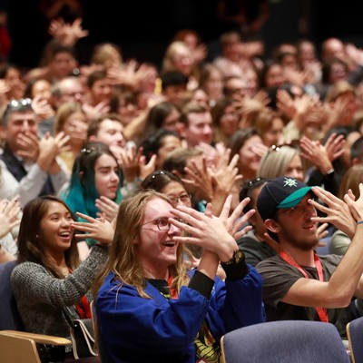 A group of people clapping.