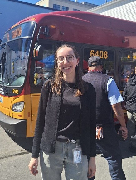 A woman in front of a bus