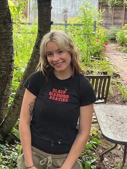 Jean Simpson Standing in a Garden