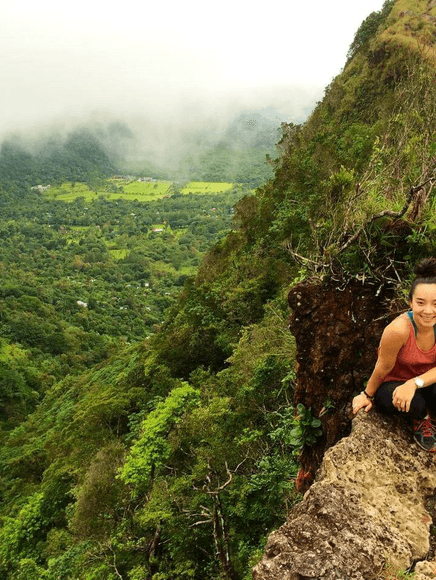 Student sitting on mountainside