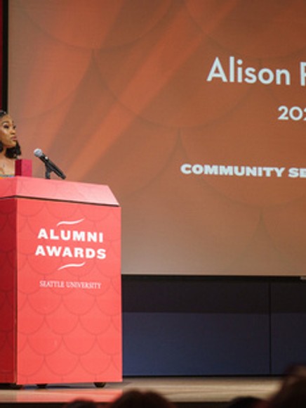 Woman presenting the Alumni Awards