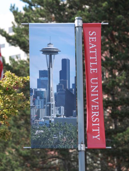 Banners on campus with Seattle University logo and picture of Seattle and the Space Needle