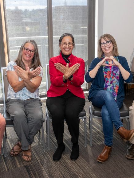 MAP faculty making Redhawk with their hands