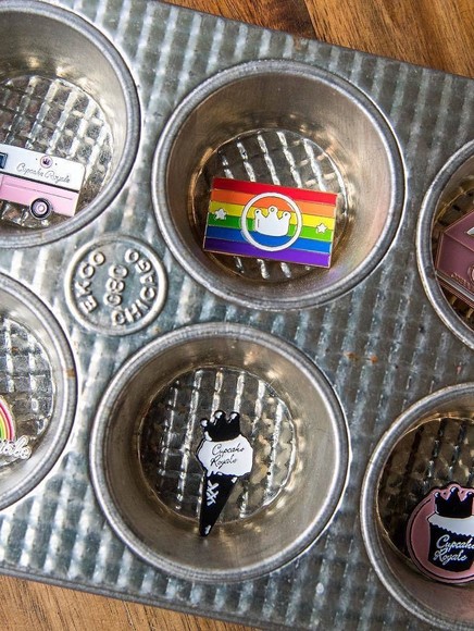 A cupcake baking tin with various emblems and charms