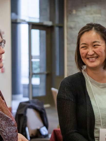 Nonprofit leadership student smiles in conversation