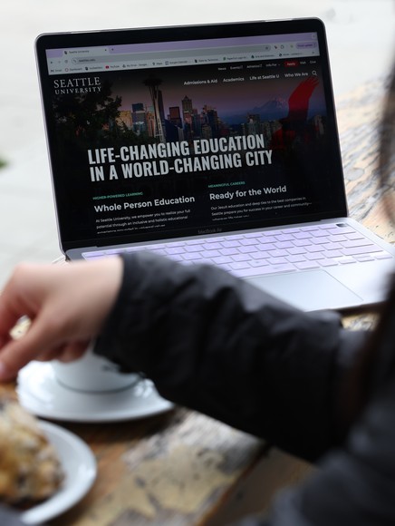 Student on laptop browsing Seattle U website